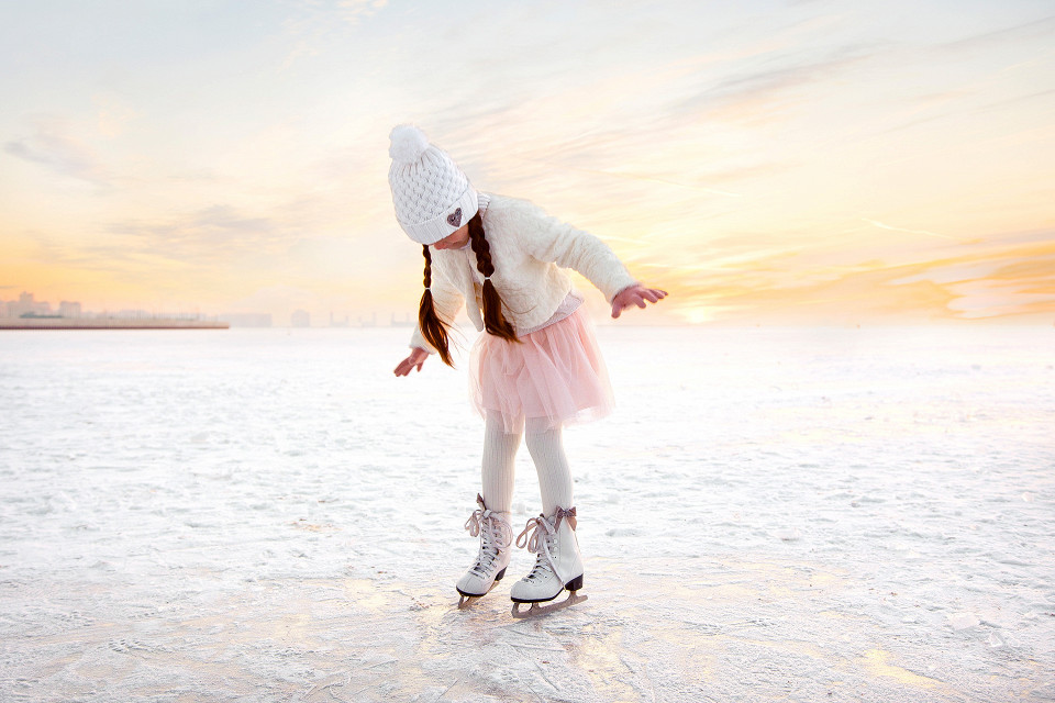 little-girl-skating-on-ice-in-evening-sunset-light