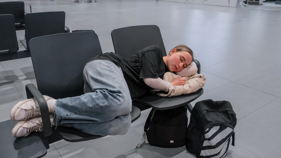Девушка спит в аэропорту